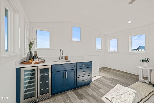 bar featuring vaulted ceiling, sink, a wealth of natural light, and wine cooler