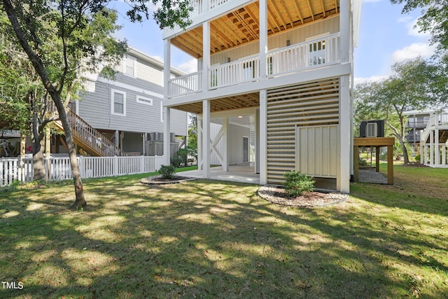 rear view of house featuring a lawn