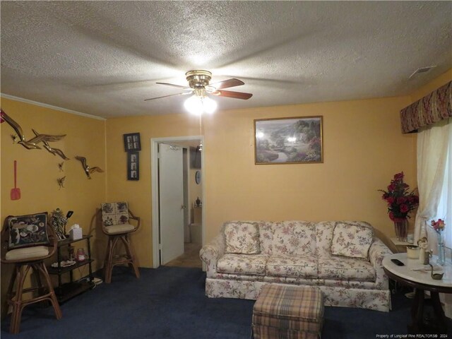 living room with ceiling fan, carpet, and a textured ceiling