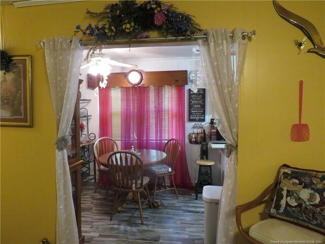 dining space with dark hardwood / wood-style flooring