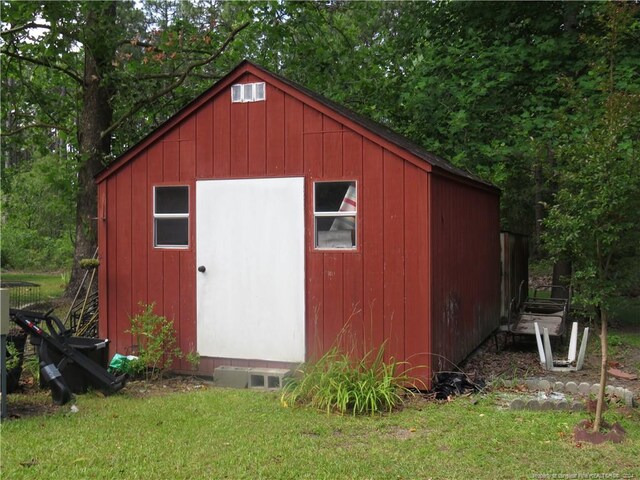 view of outbuilding with a lawn