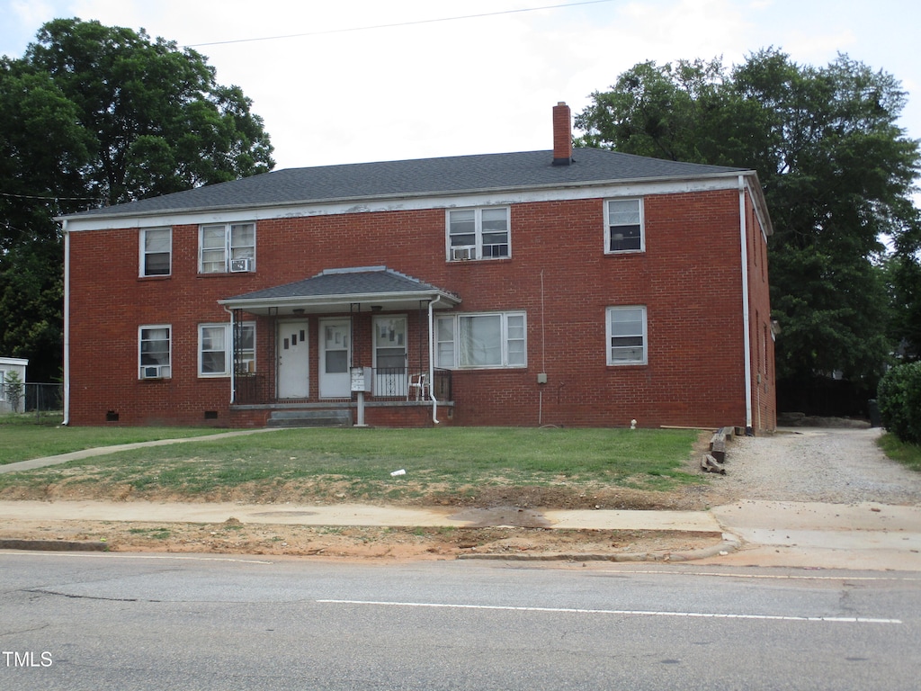 view of front facade with a front yard and a porch