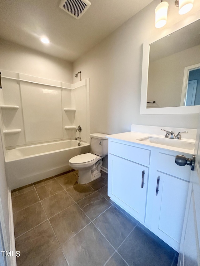 full bathroom with tile patterned flooring, shower / tub combination, vanity, and toilet