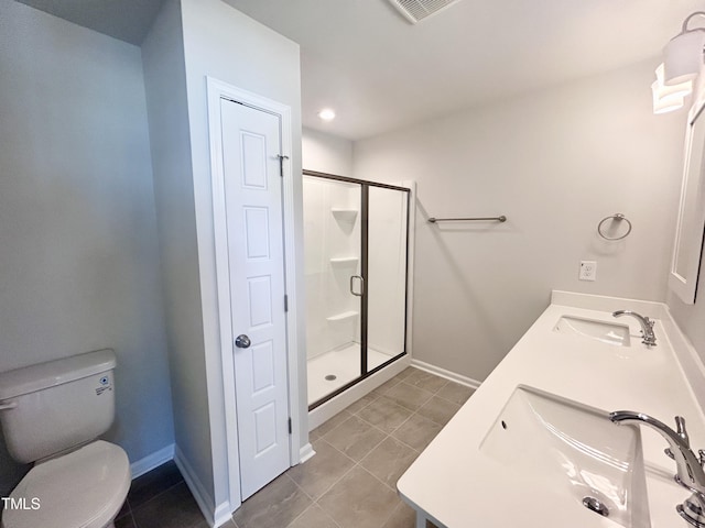 bathroom featuring tile patterned floors, vanity, toilet, and a shower with door