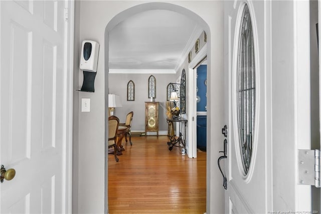 entryway with hardwood / wood-style flooring and ornamental molding