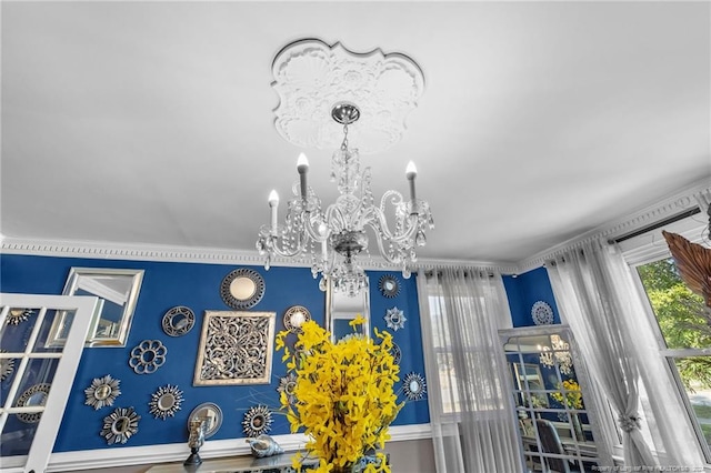 interior details featuring crown molding and a chandelier