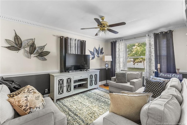 living room featuring ceiling fan, wood-type flooring, and ornamental molding