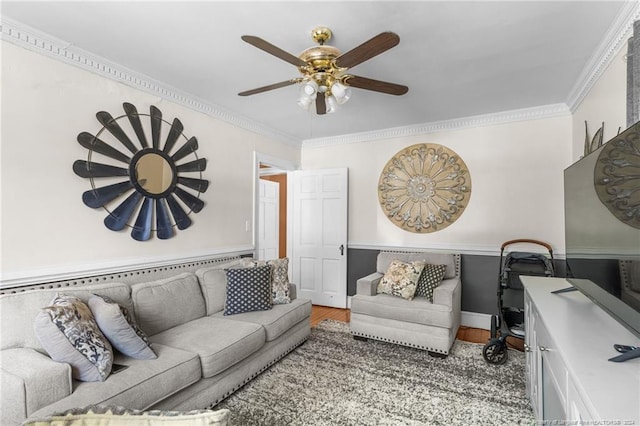 living room with hardwood / wood-style flooring, ceiling fan, and ornamental molding