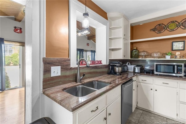 kitchen with white cabinets, sink, stainless steel appliances, and hanging light fixtures