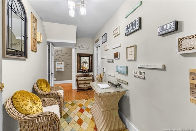 hallway with hardwood / wood-style flooring