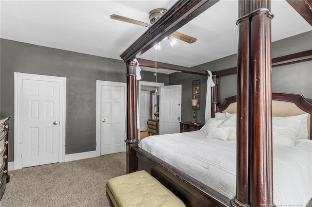 bedroom with carpet, ceiling fan, and beam ceiling