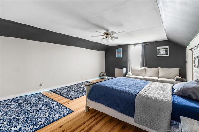 bedroom with hardwood / wood-style floors, ceiling fan, and lofted ceiling