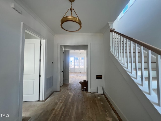 hall with hardwood / wood-style flooring and ornamental molding