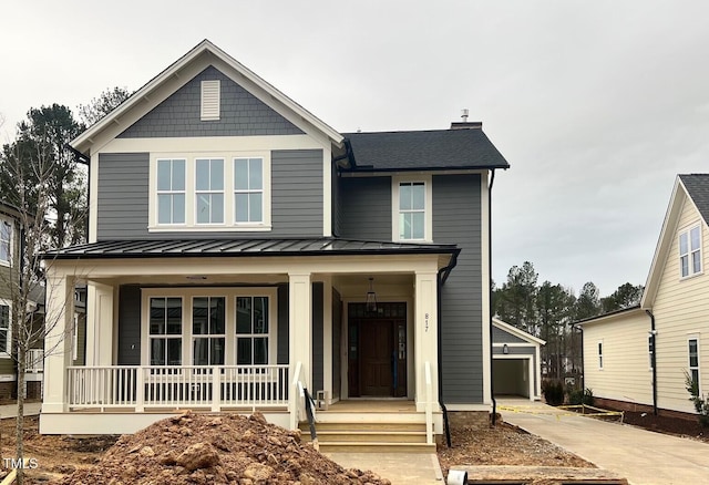 view of front of property with a porch and a garage