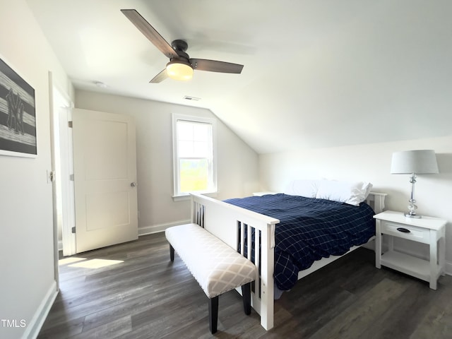 bedroom featuring dark hardwood / wood-style floors, vaulted ceiling, and ceiling fan