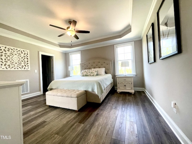 bedroom with multiple windows, a raised ceiling, ceiling fan, and ornamental molding