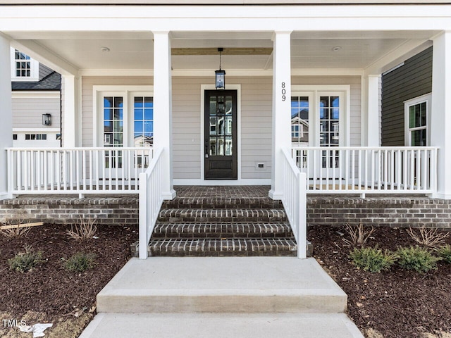 entrance to property featuring a porch