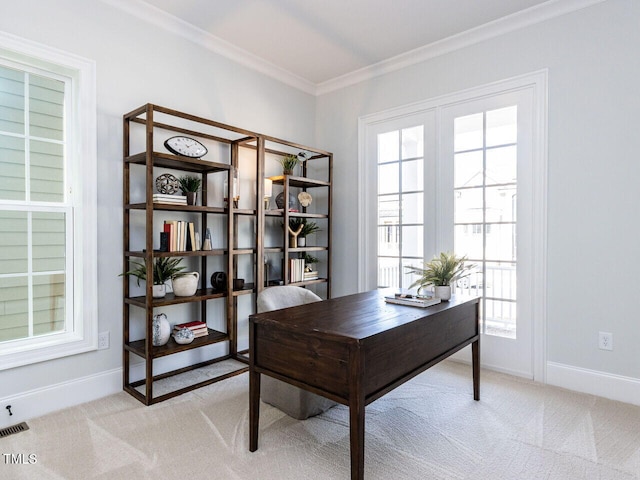 office area with baseboards, crown molding, and light colored carpet