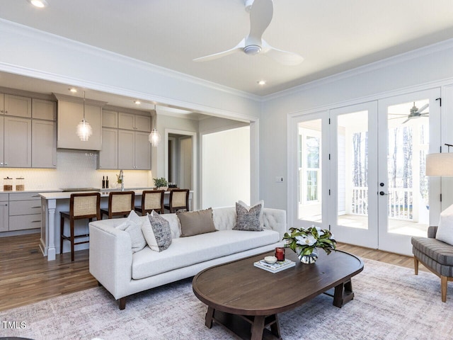 living area with ceiling fan, french doors, light wood-type flooring, and crown molding