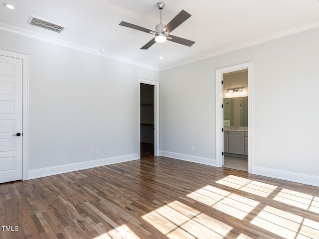 unfurnished bedroom with ornamental molding, wood finished floors, visible vents, and baseboards