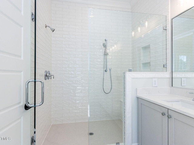 full bath with a stall shower and vanity