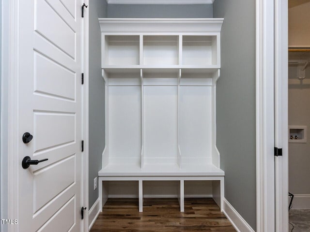 mudroom with dark wood-type flooring and baseboards