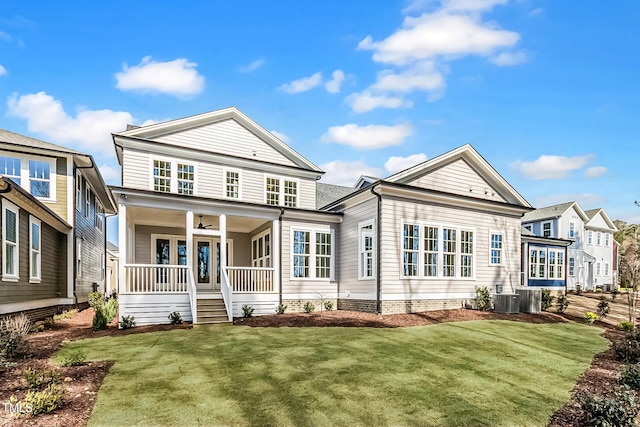 back of property featuring a porch, a yard, a ceiling fan, and central AC