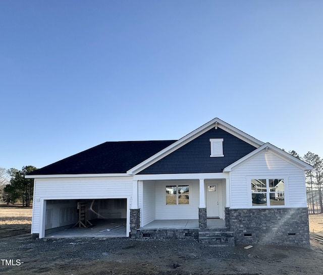 view of front of home with a porch, an attached garage, dirt driveway, and crawl space