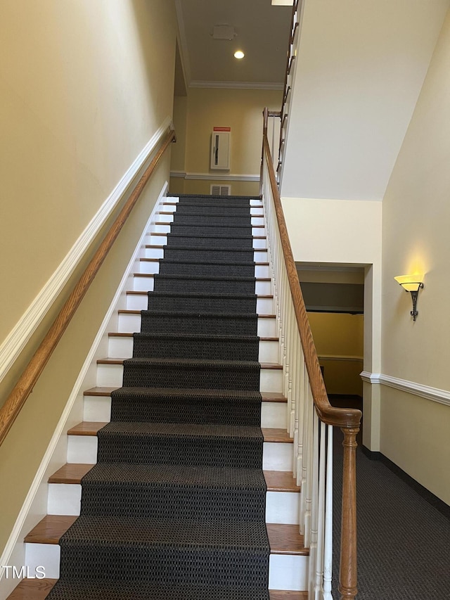 staircase featuring ornamental molding