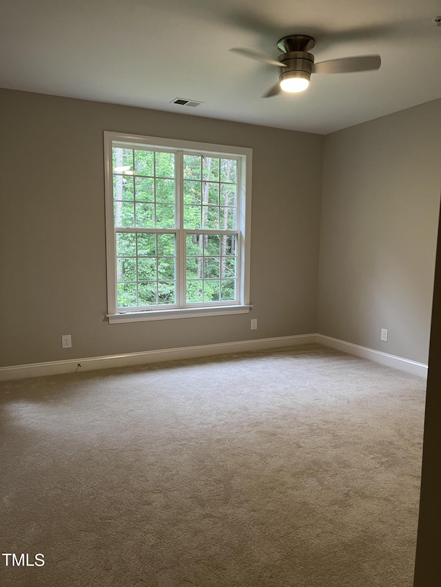 empty room with light carpet and ceiling fan