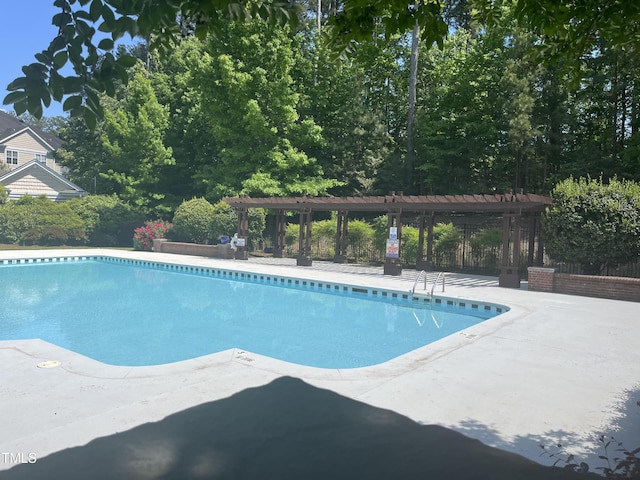 view of swimming pool with a pergola and a patio