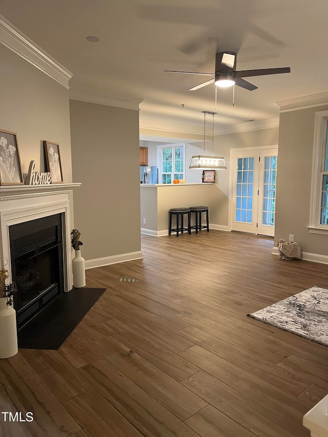 living room with hardwood / wood-style flooring, ceiling fan, and ornamental molding