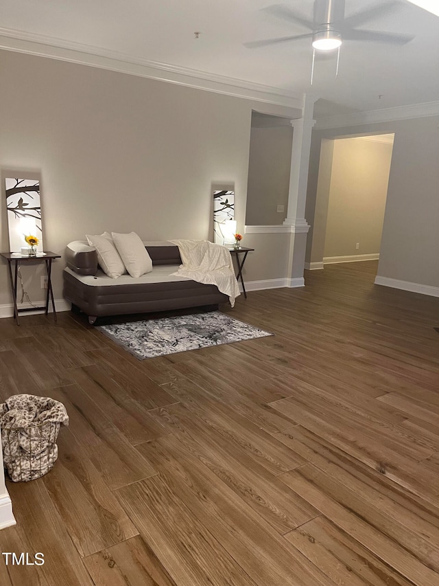 living room featuring hardwood / wood-style flooring, ceiling fan, and crown molding