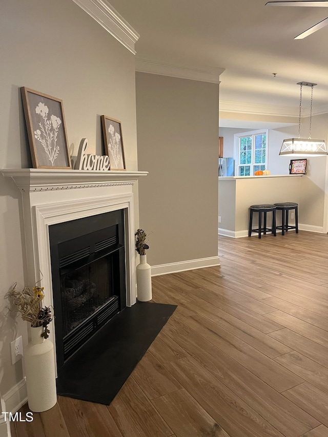 living room with wood-type flooring and ornamental molding