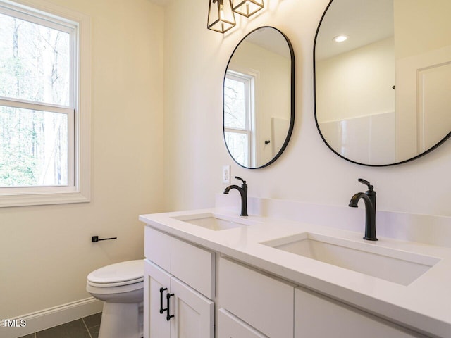 bathroom featuring toilet, tile patterned flooring, and vanity