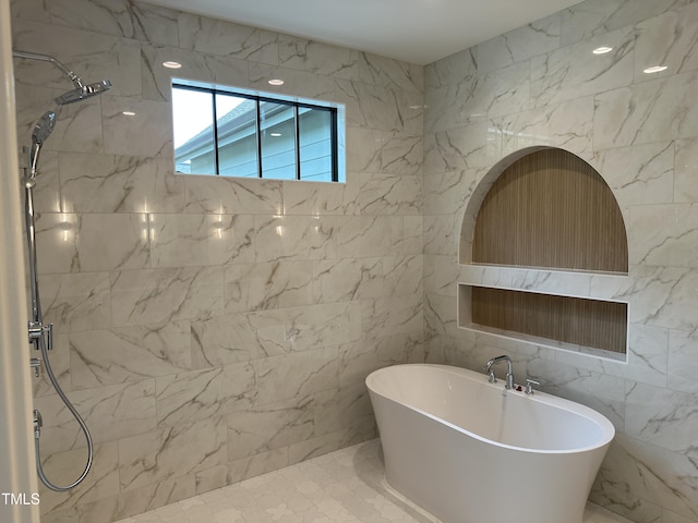 bathroom featuring a freestanding bath, a shower, and tile walls