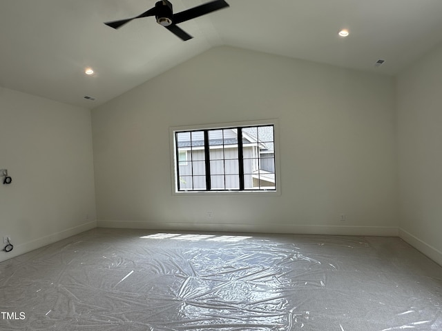 empty room featuring lofted ceiling, a ceiling fan, visible vents, and baseboards