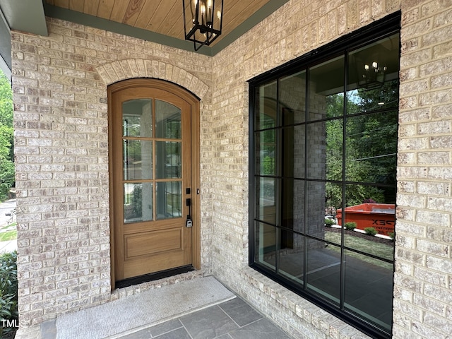 doorway to property with brick siding