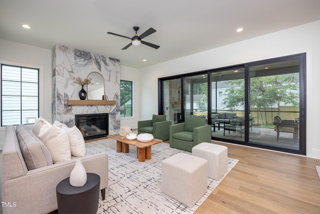 1000 Marilyn Dr, Raleigh, NC 27607 - living room featuring wood finished floors, a premium fireplace, healthy amount of natural light, a ceiling fan, and recessed lighting