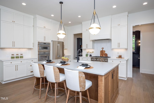 1000 Marilyn Dr, Raleigh, NC 27607 - kitchen featuring appliances with stainless steel finishes, decorative backsplash, wood finished floors, and recessed lighting
