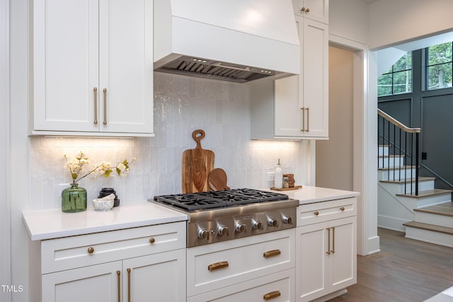 1000 Marilyn Dr, Raleigh, NC 27607 - kitchen with custom range hood, stainless steel gas cooktop, light countertops, and backsplash