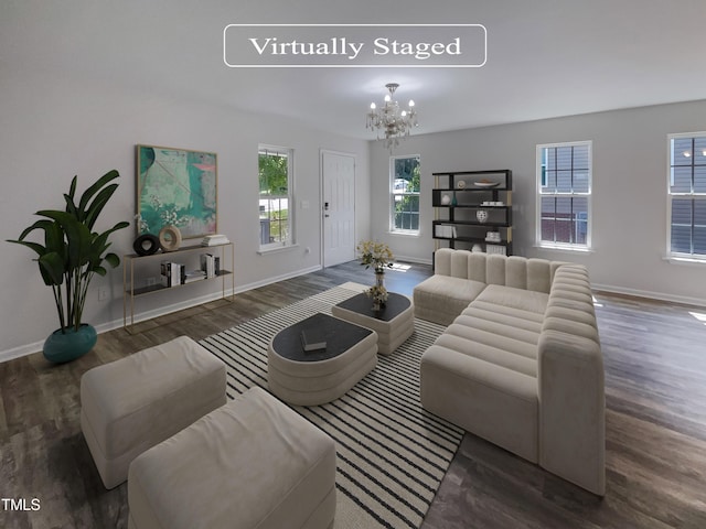 living room with a notable chandelier, dark hardwood / wood-style floors, and a healthy amount of sunlight