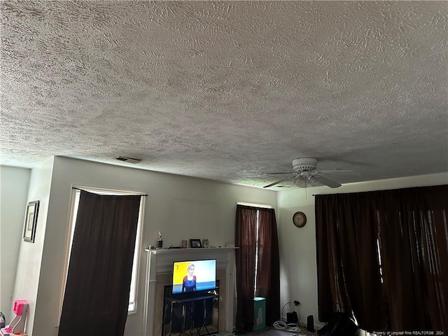 unfurnished living room with ceiling fan