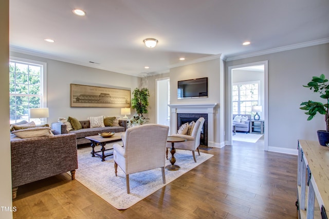 living area featuring ornamental molding, a fireplace with flush hearth, recessed lighting, and dark wood-type flooring