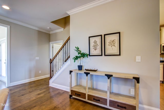 interior space featuring baseboards, ornamental molding, wood finished floors, and recessed lighting