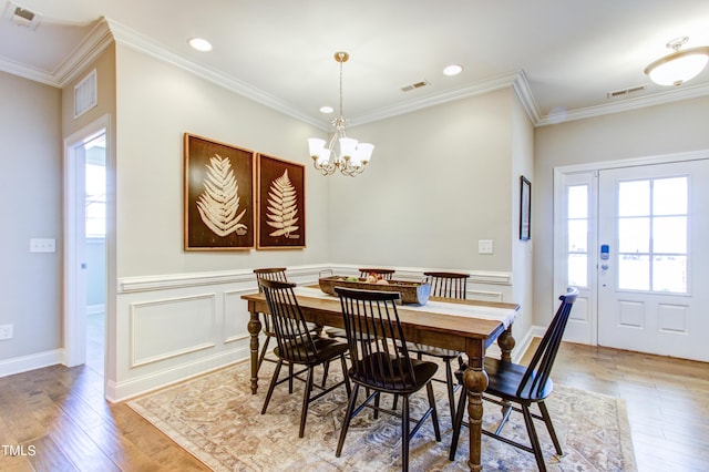 dining room featuring light wood-type flooring and visible vents