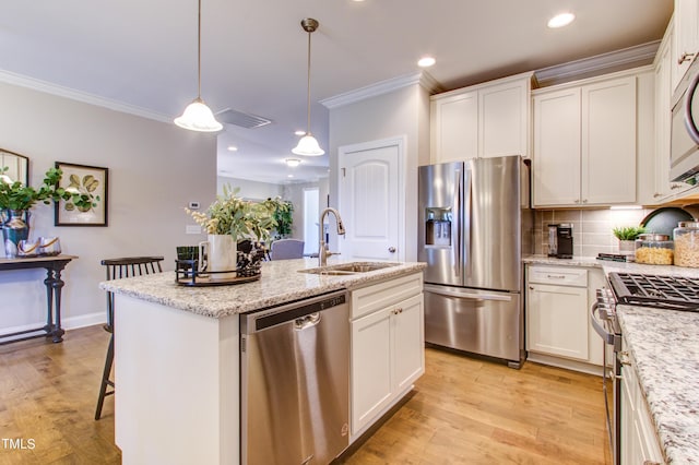 kitchen with a sink, white cabinets, and stainless steel appliances