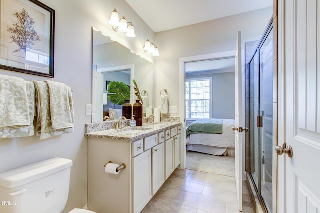 bathroom featuring ensuite bathroom, a sink, a shower with shower door, and double vanity