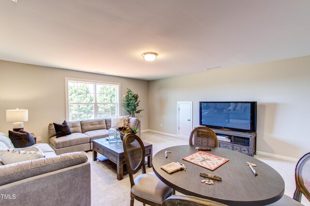 living room featuring baseboards, visible vents, and light colored carpet