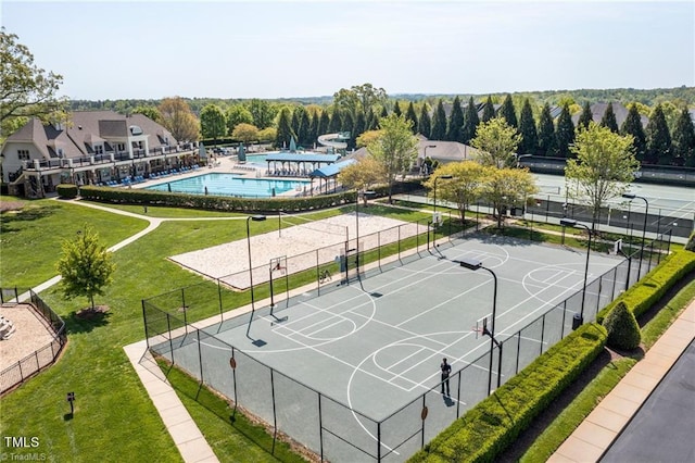 view of basketball court featuring fence, volleyball court, and a yard